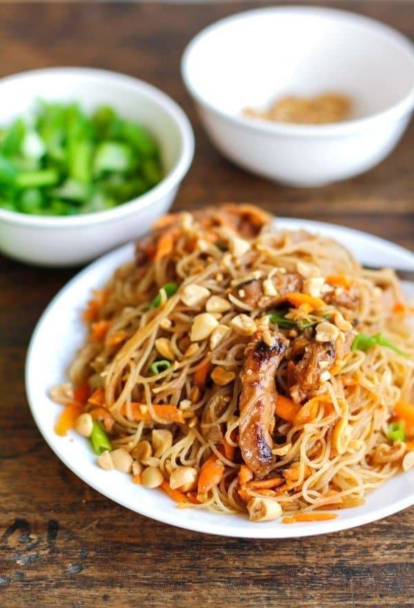 Hoisin pork with rice noodles on a white plate.