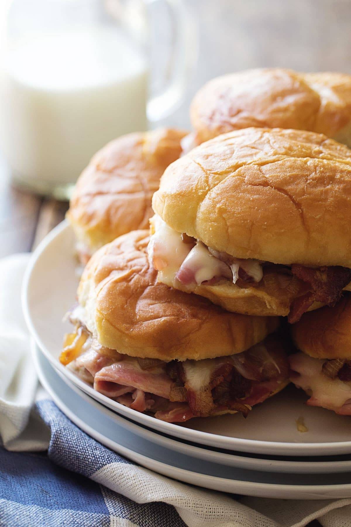 Ham and Cheese Sandwiches stacked on a plate.
