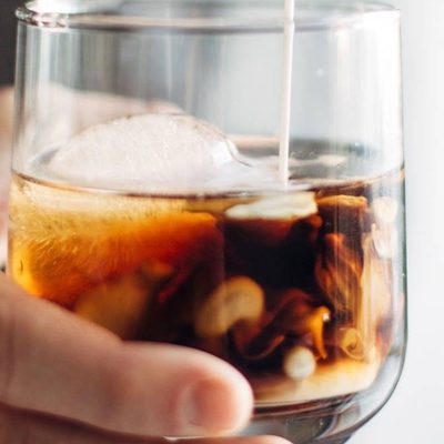Cinnamon White Russian in a glass with cream.