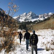 Friends walking in the snowy mountains.