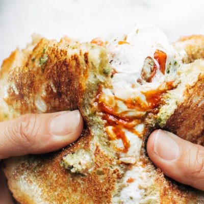 Caprese Grilled Cheese being pulled apart.
