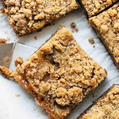 Caramel Apple Crisp Bars sliced with spatula.