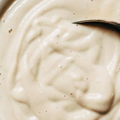 Cashew Sauce in a bowl with a spoon.