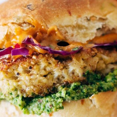Spicy Cauliflower Burger held by hand.