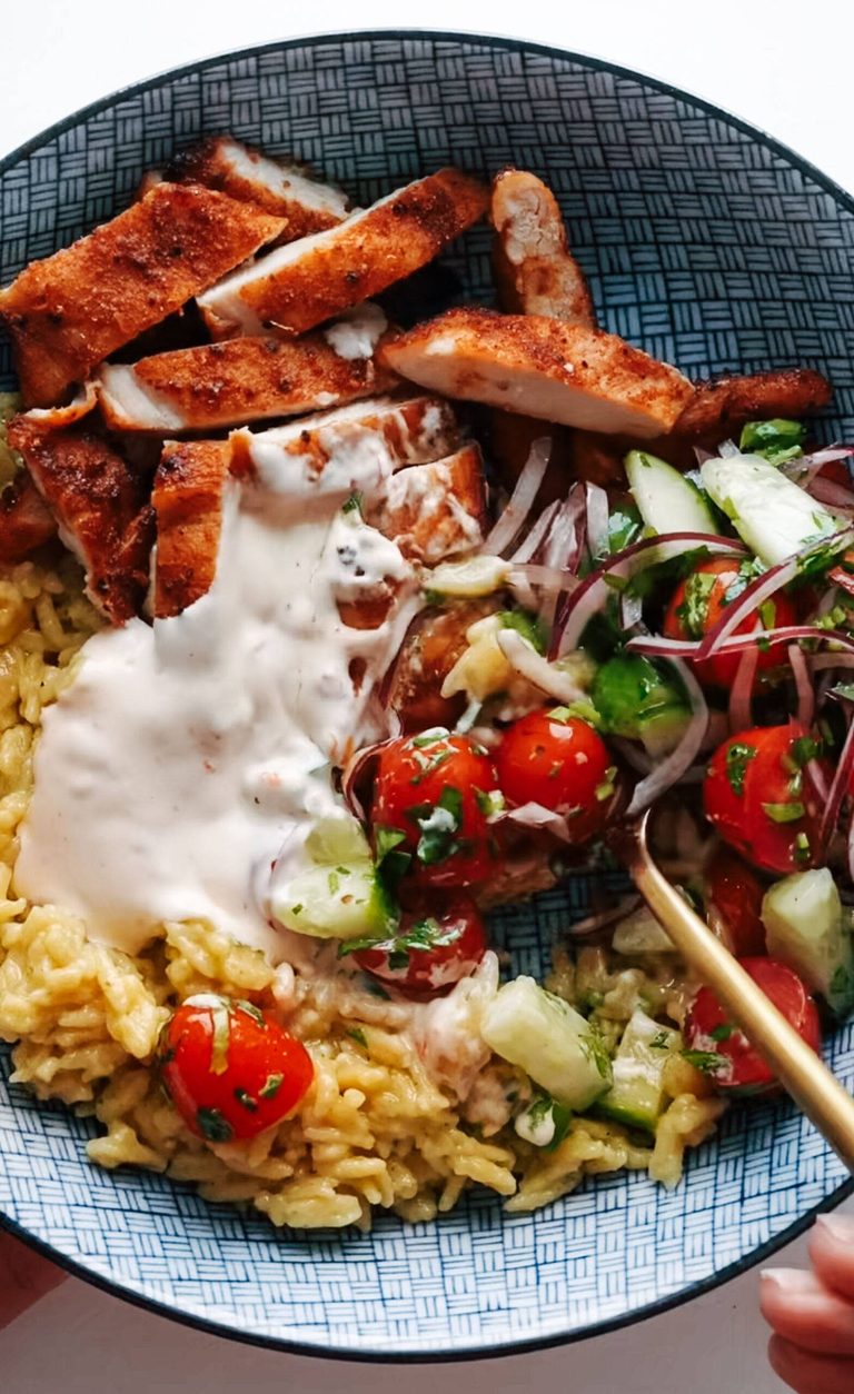 Chicken in a bowl with banza arice nd tomato salad.