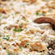 Chicken Tetrazzini baked in a pan with wooden spoon.
