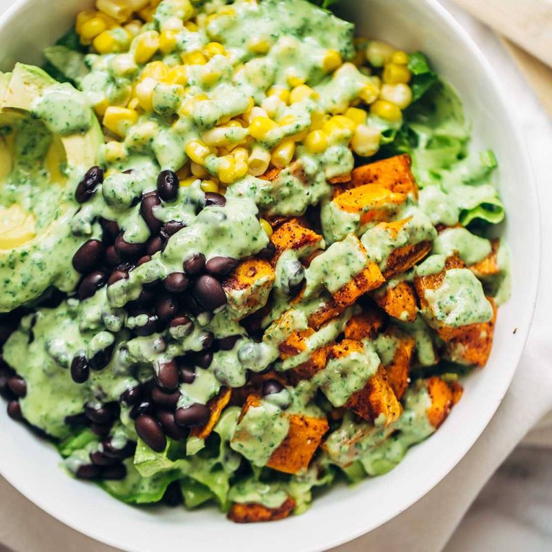Spicy Southwestern Salad in a serving bowl with avocado dressing.