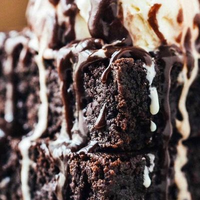 Extra Fudgy Coconut Oil Brownies on a plate with ice cream.
