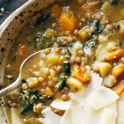 Detox Lentil Soup in a bowl with a spoon.