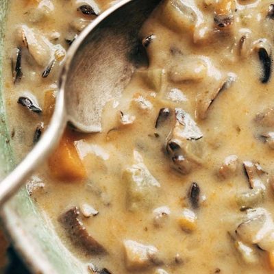 Instant Pot Wild Rice soup in bowl with spoon.