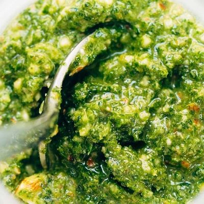 Kale Pesto in a jar with spoon.