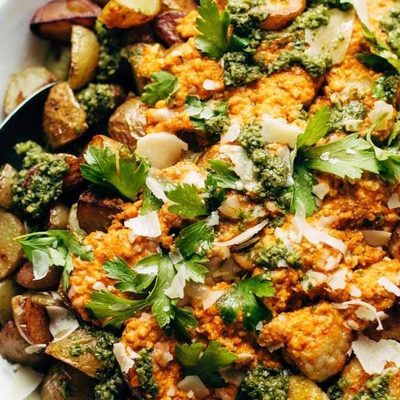 Mini Chicken Meatballs with roasted potatoes and romesco sauce in a bowl.
