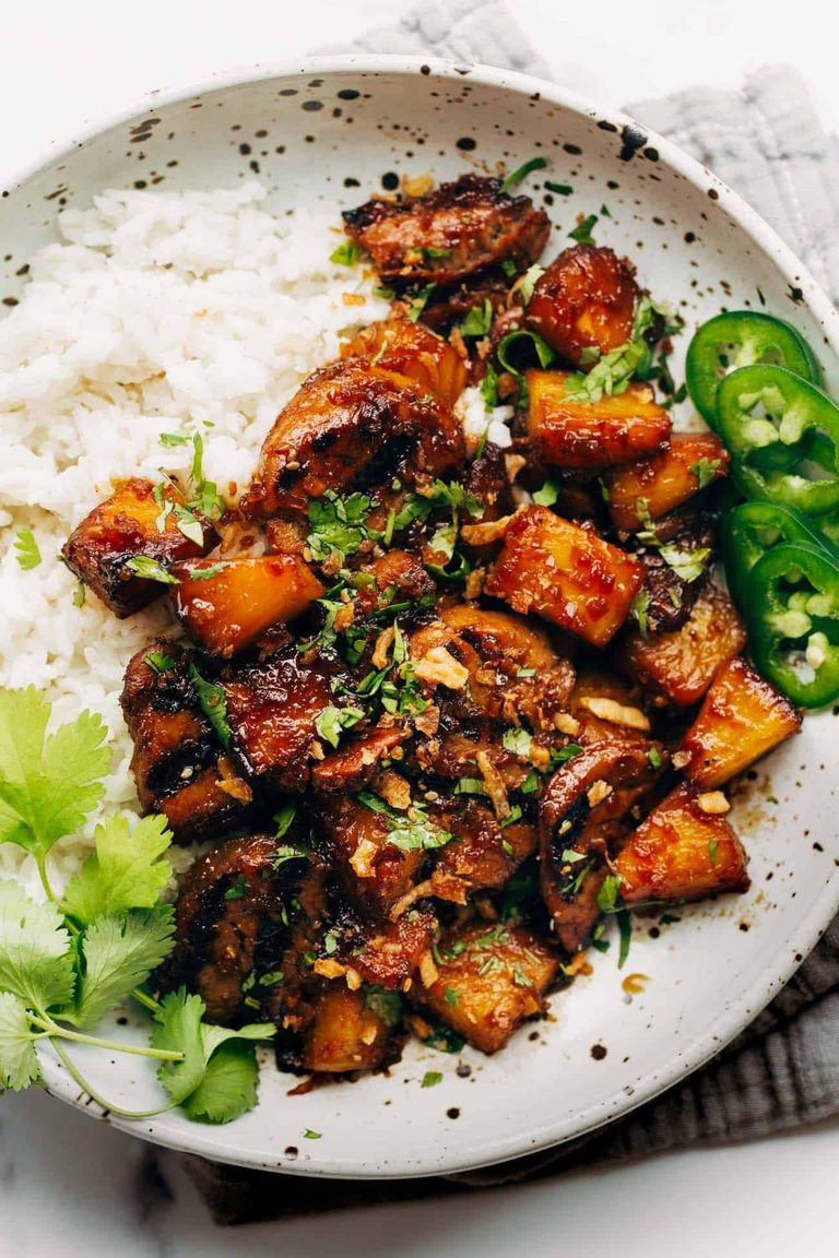 Pineapple pork in a bowl with rice.