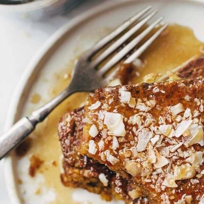 Pumpkin Bread French Toast on a plate with syrup.