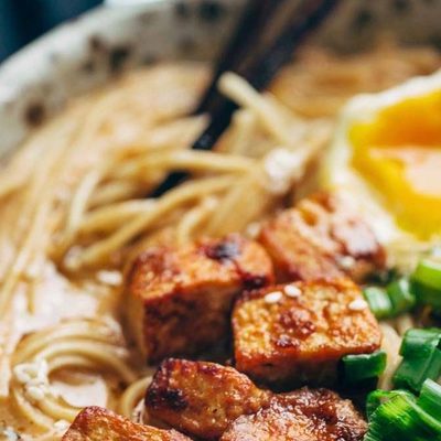 Homemade Spicy Ramen in a bowl with tofu and chopsticks.