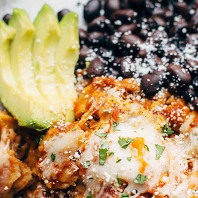 Sofritas Casserole on a plate with black beans and avocado.