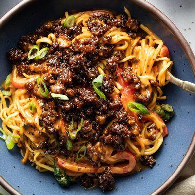 Peanut noodles topped with ground beef.