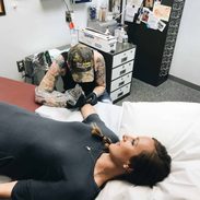 Lindsay getting a tattoo.