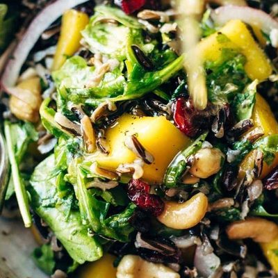 Thanksgiving Salad in a bowl with dressing.