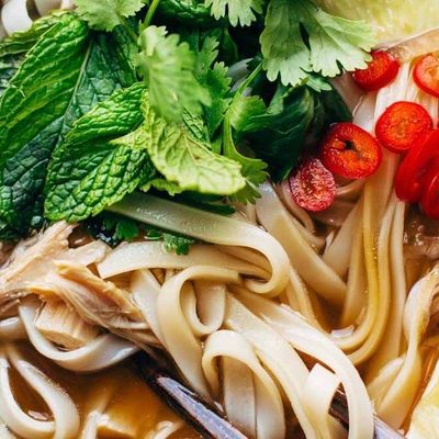 Turkey Pho in a bowl with chopsticks.