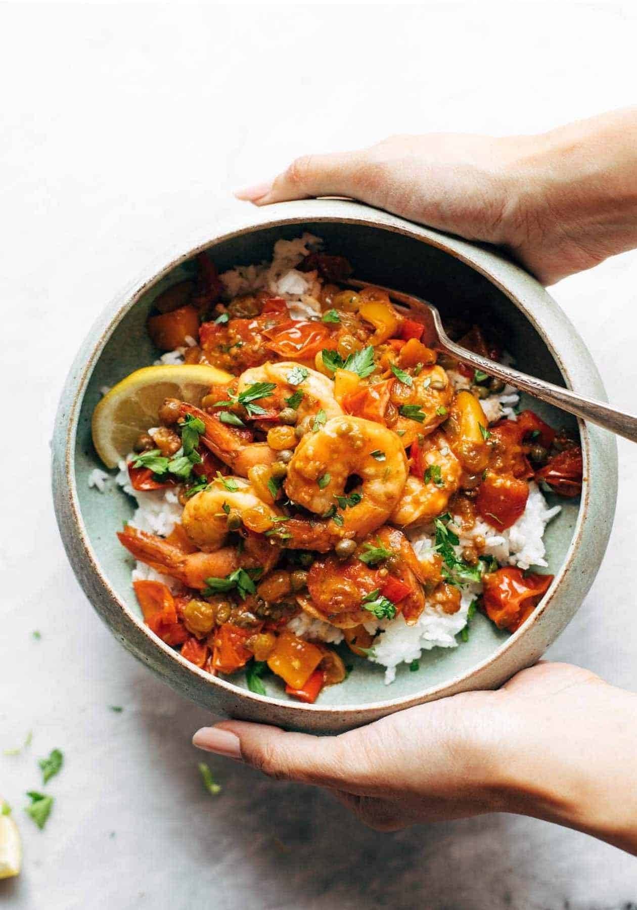 Shrimp veracruz in a bowl with rice.